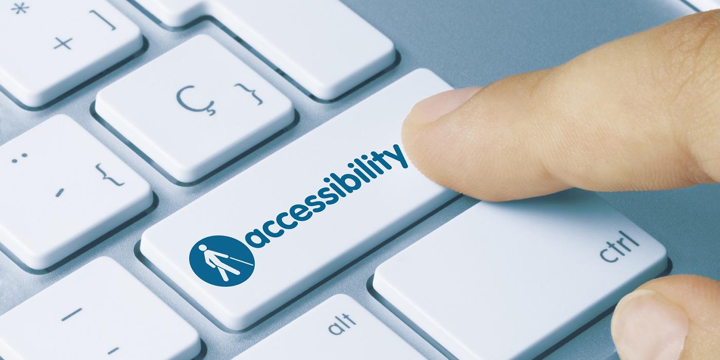 image of a person pressing a key on a keyboard. This key has 'accessibility' written on it.